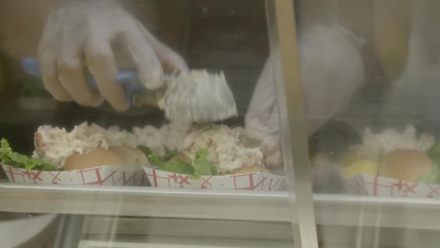 An employee at a restaurant prepares food