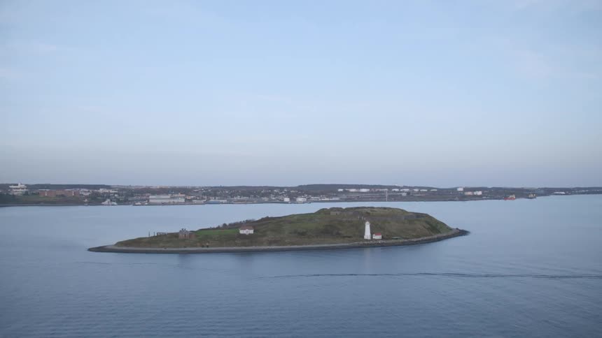 An island in the water with the skyline in the distance