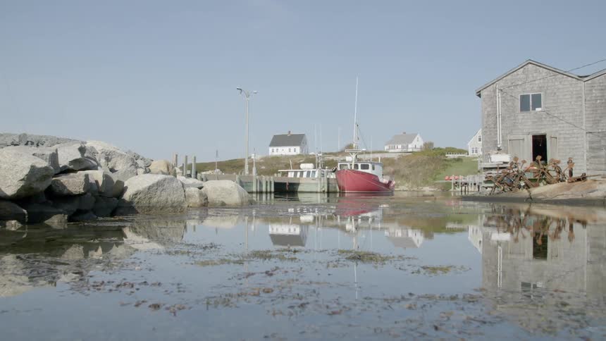 A boat sits in the water next to a building