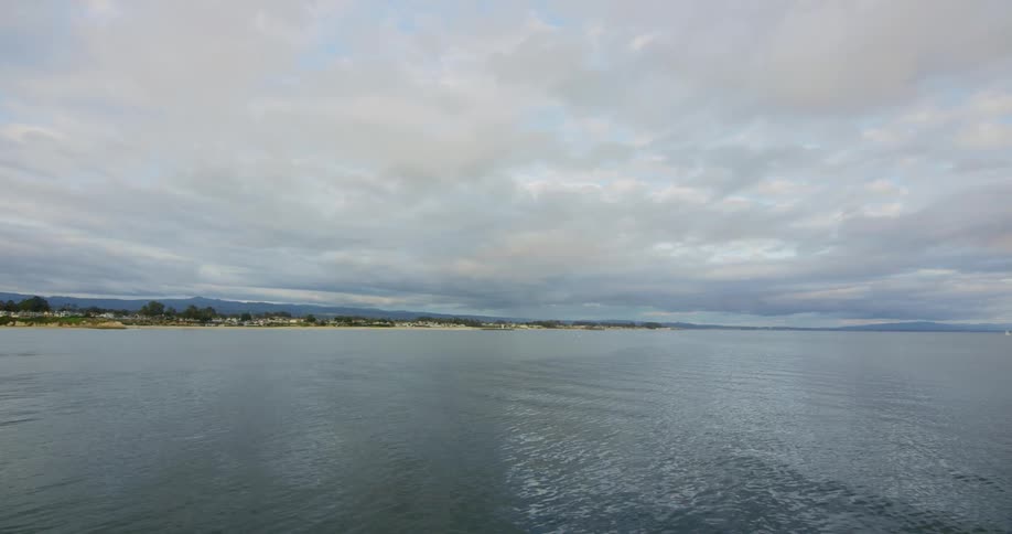 The water is calm on a cloudy day