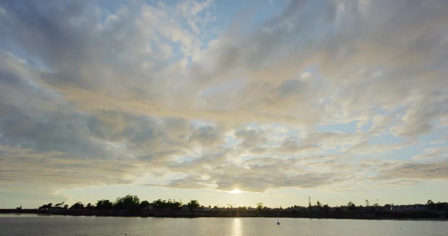 The sun sits behind the clouds