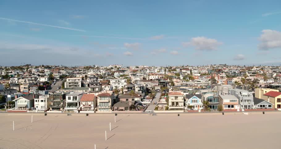 Aerial view of the coastal city and empty golden beach