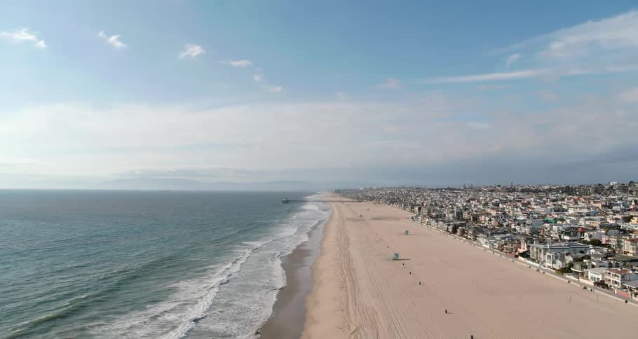 Rolling waves on the beach by a coastal town