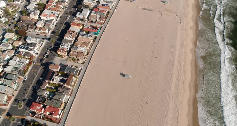 Aerial view of the coastal city and empty beach