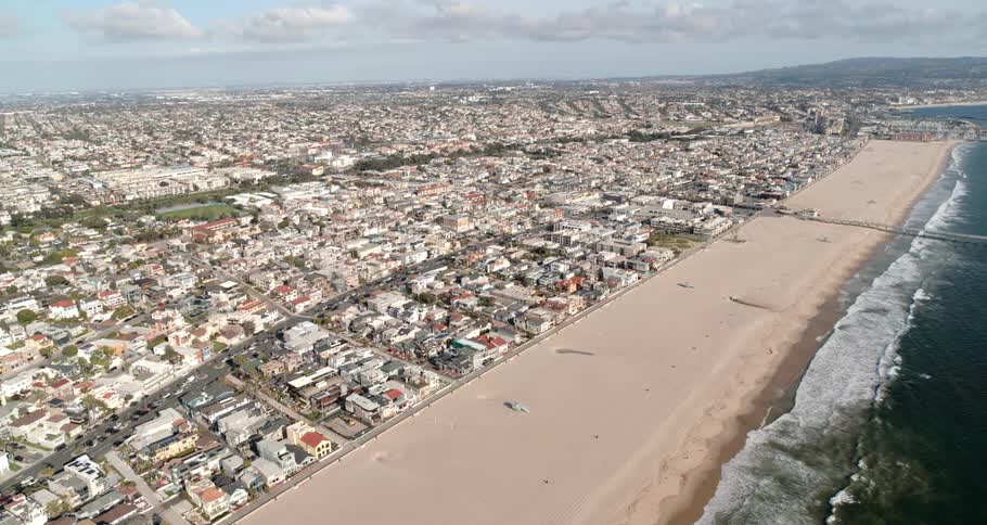 Rolling waves on the beach by a coastal town