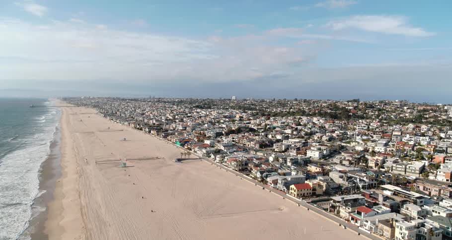 Aerial view of the coastal city and empty beach