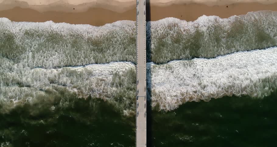 Birds eye view of waves rolling in to the shore