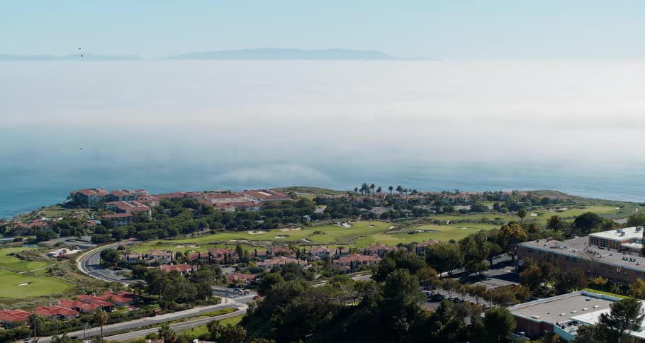 A town close to the coast with houses roads and vehicles