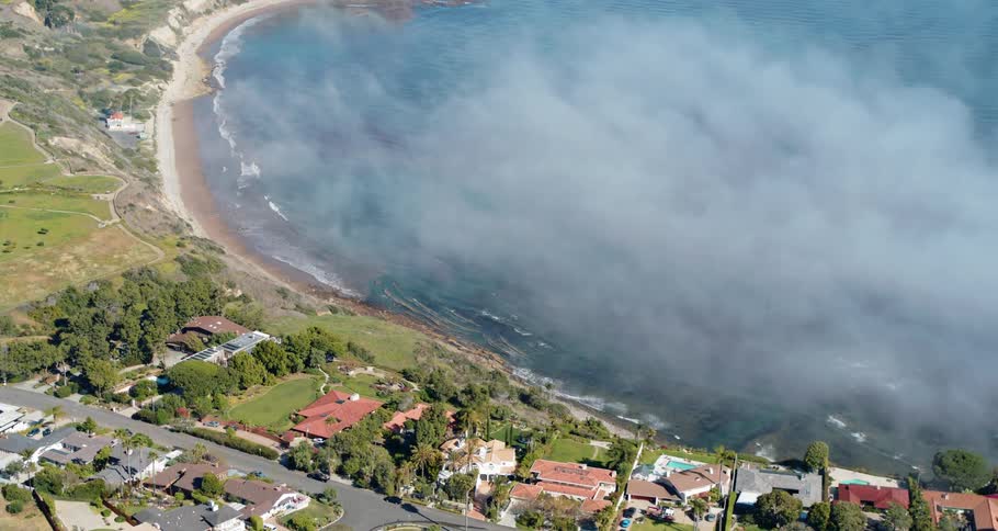 Smoke sits over the water