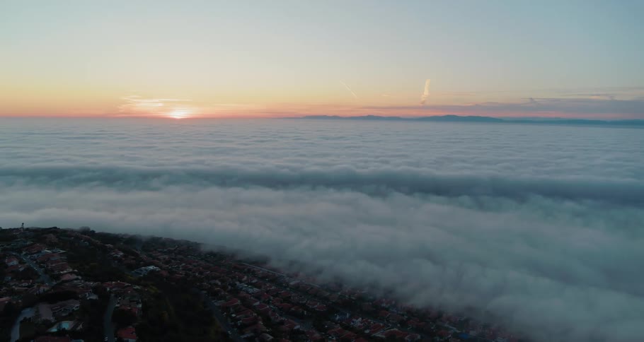 The clouds roll up on the town from the shore