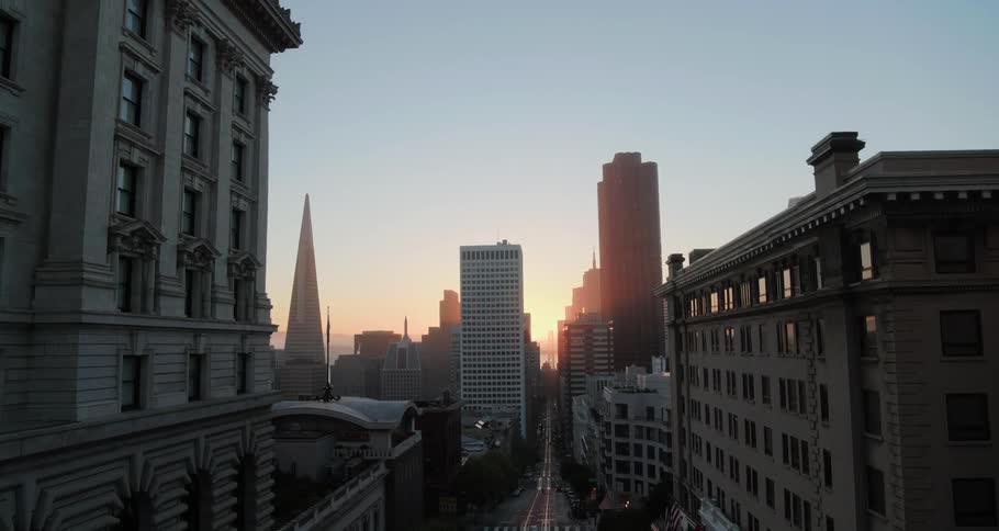 Rising aerial shot of a city at dawn or dusk