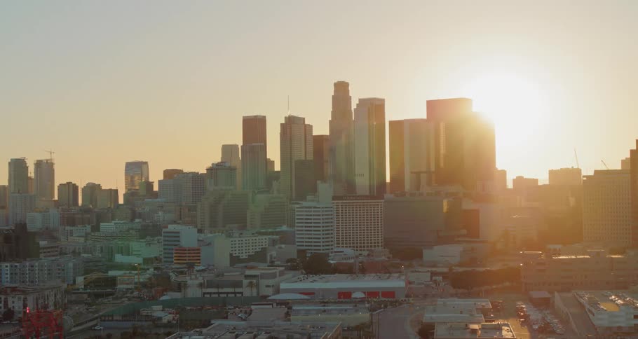 A city skyline with the sunset in the background