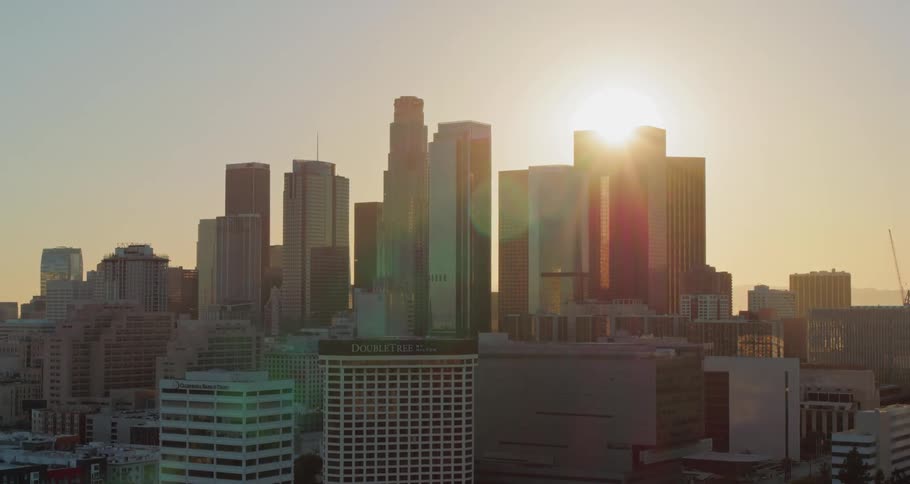 Sun edges over the skyscrapers as fog shrouds area past downtown