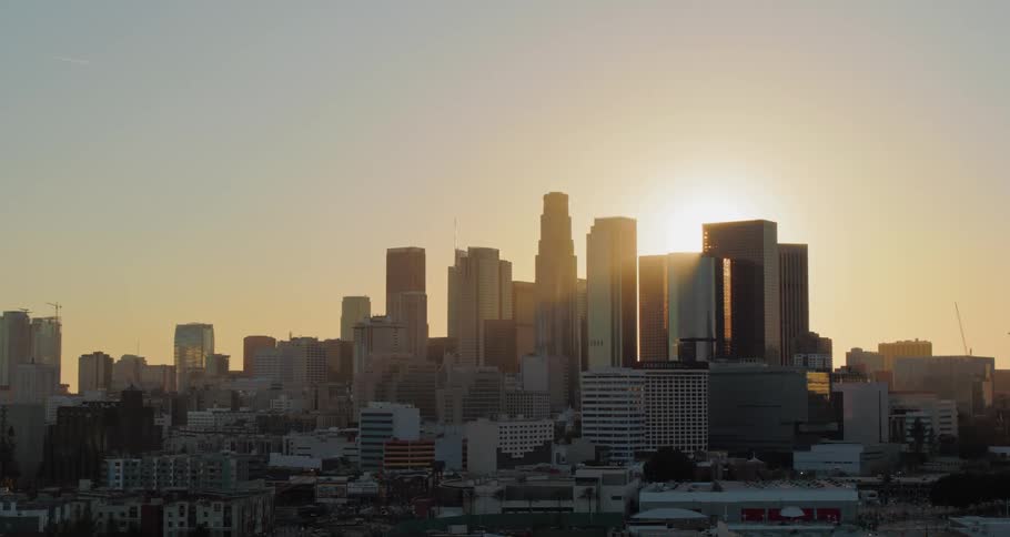 The sun shines over high rise buildings