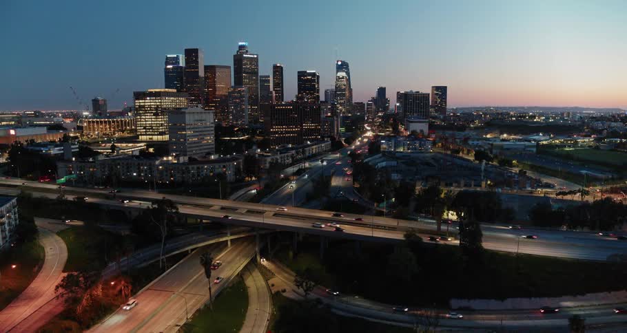 The many roads and bridges of a busy freeway in a city at sunset
