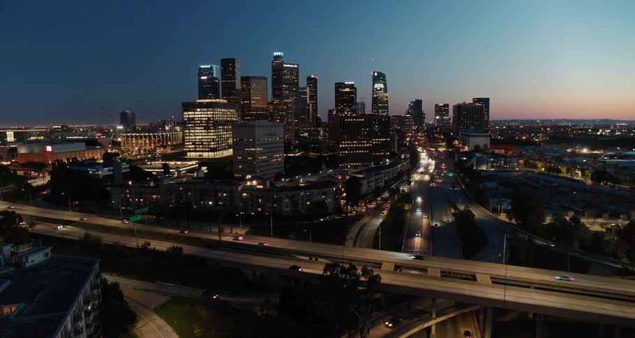 Cars driving down a highway in a city