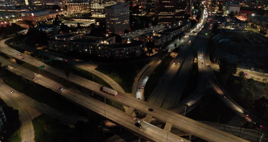 Cars driving on a highway with the city skyline in the background