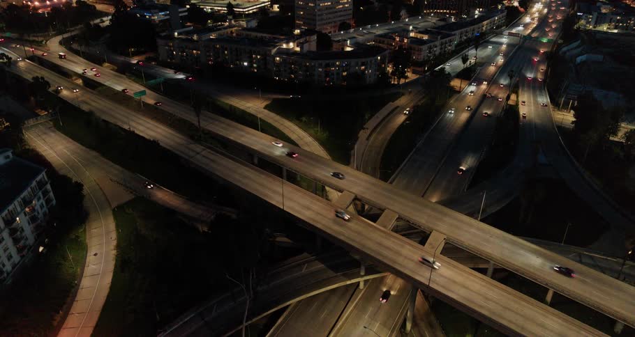 Overhead view of cars riding on vertically overlapped highways and off ramps