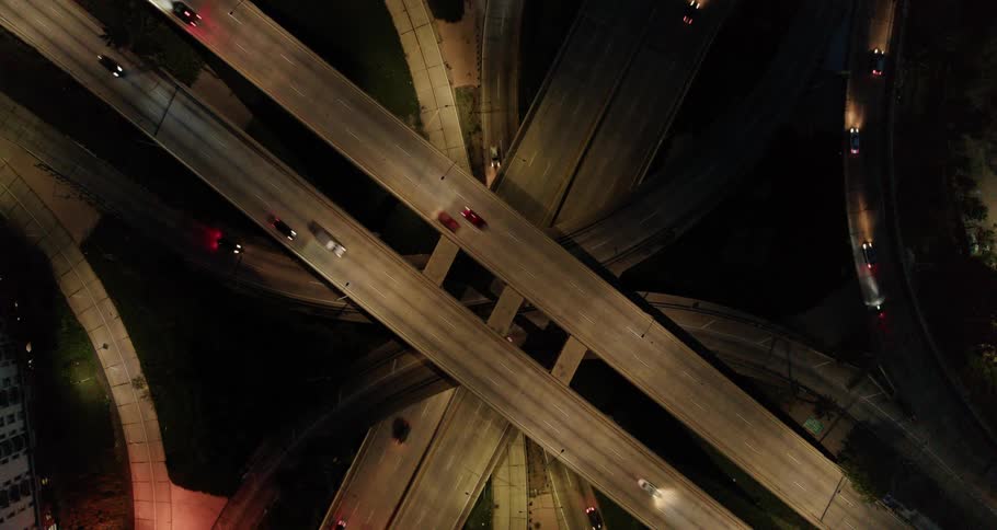 Aerial view of traffic going through a highway intersection at night