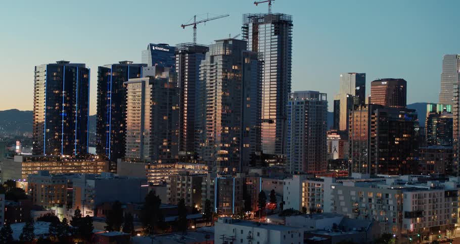 Buildings and skyscrapers stand in the city under a blue sky