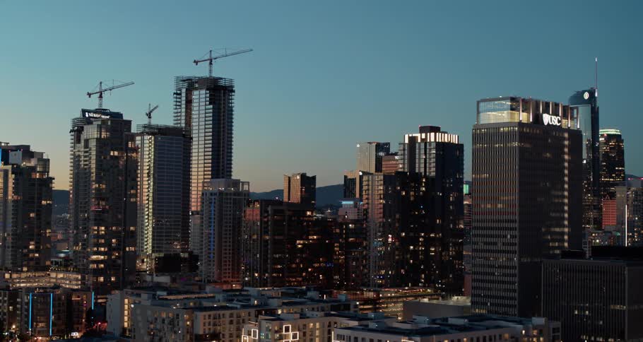 Aerial view of the illuminated high rise buildings at dusk