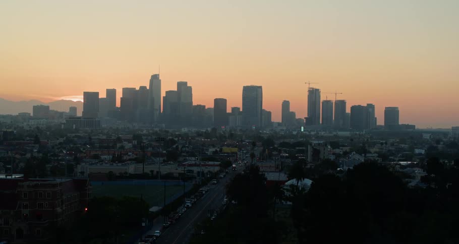 Aerial view of a distant city skyline at dawn