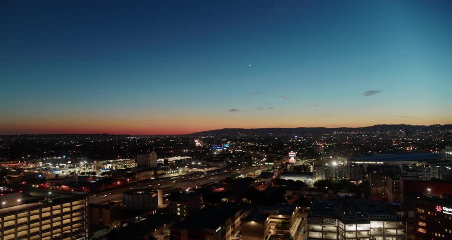 An aerial view of cars driving through a downtown city was displayed