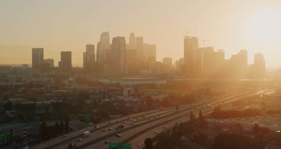 An aerial view of a downtown city and a highway is displayed