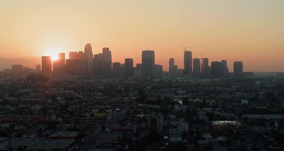 Sun setting behind the city skyline in a metropolis area