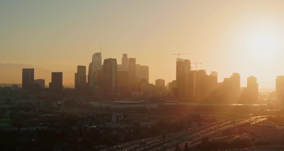 Cars driving in front of the city skyline