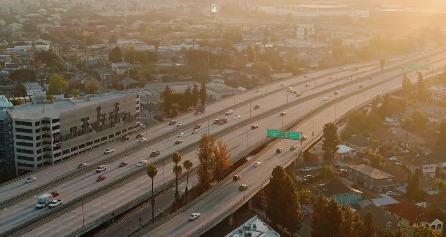 Cars driving down a highway in a city