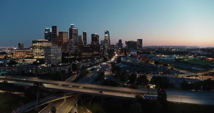 A highway with vehicles with the city skyline in the background