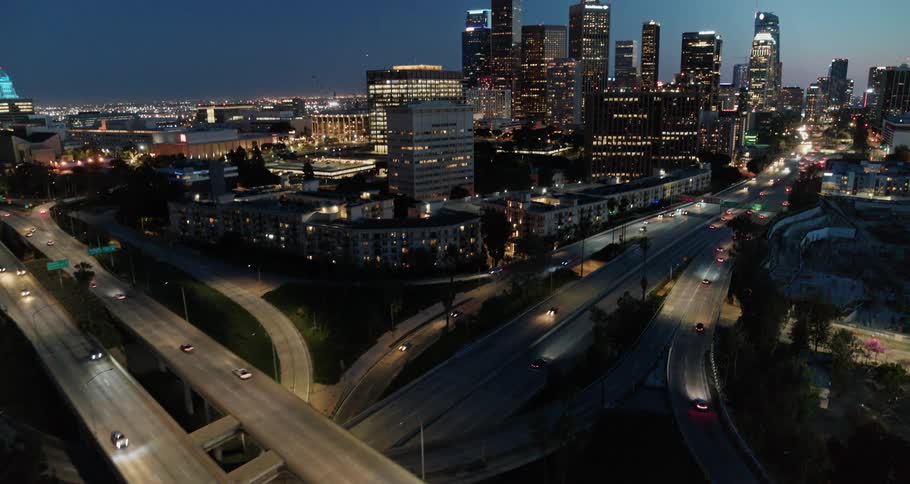 The cars drive near downtown