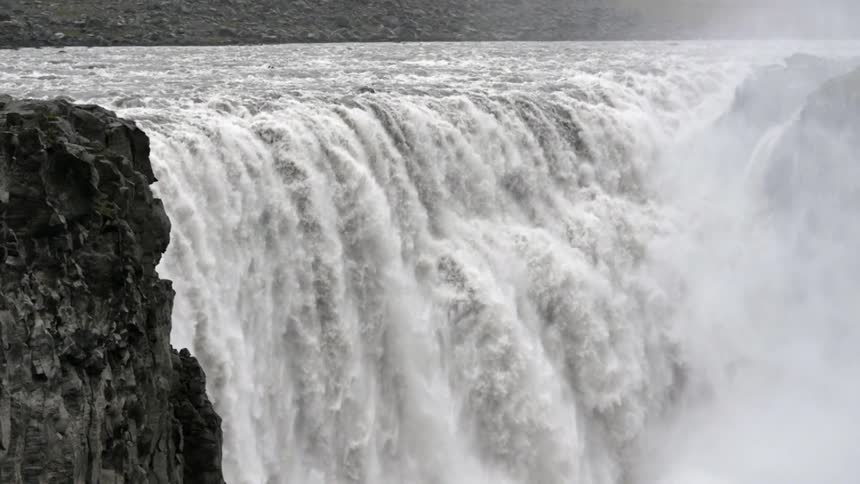 Water gushes over a waterfall