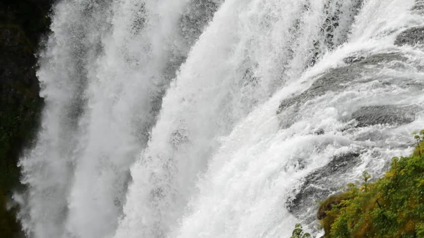 A waterfall rushing over the edge of a cliff