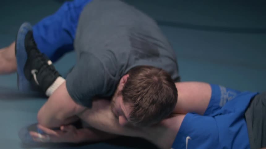 Wrestlers practice on the floor