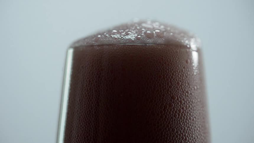 The drink begins to bubble over the glass
