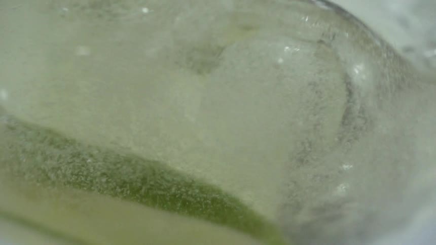The drink mixes around with the ice and lime
