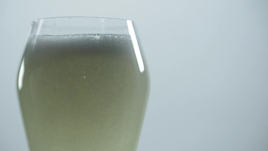 A glass fills with a beverage