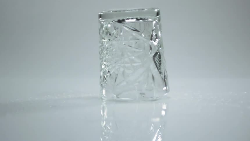 An empty cocktails glass spins around upside down