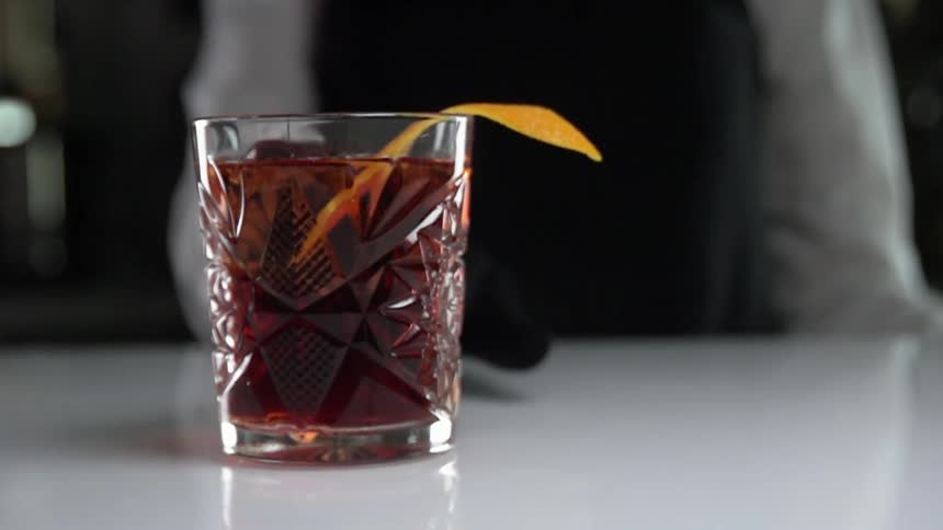 Waiter serves a glass of cocktail