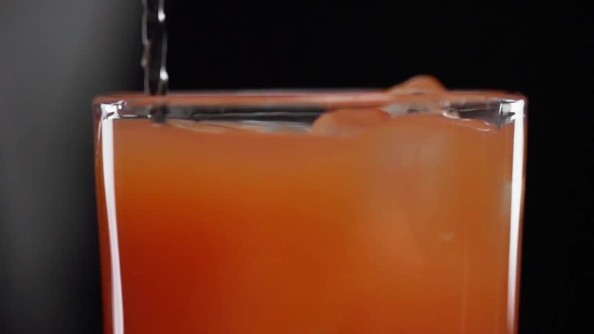 The cocktail is being stirred