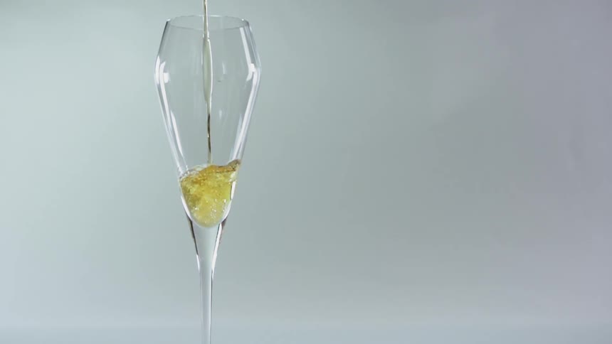 The champagne glass is being filled