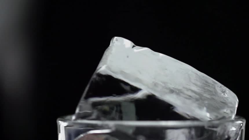 Ice cube turns around in a glass