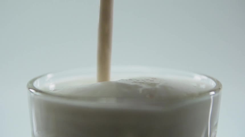 Milkshake is being poured into the glass