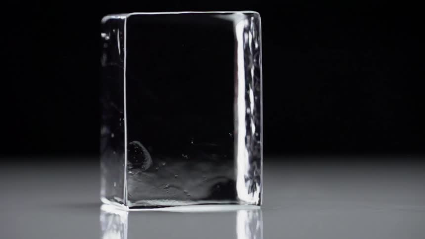 A square piece of ice spins around on a flat surface
