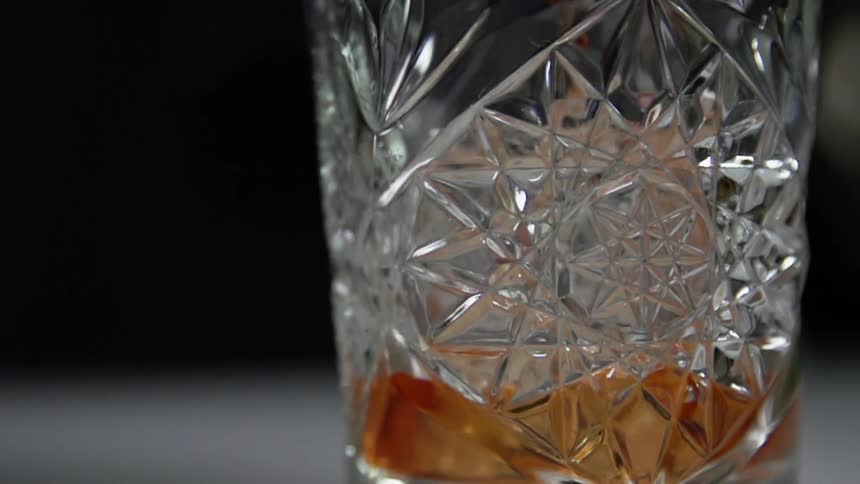 The glass is being filled with alcohol