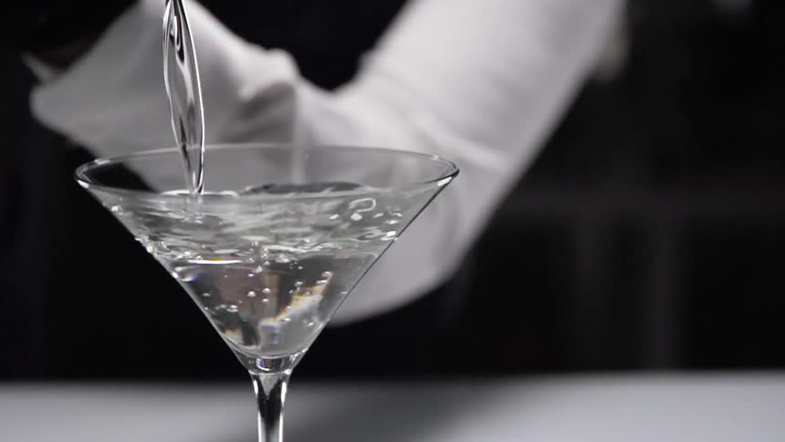 A person is pouring liquid into a glass