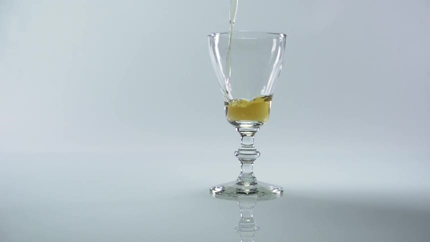 Alcohol being poured in to a glass during a photo shoot