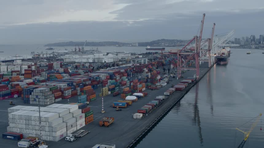 A cargo terminal and container yard sits across the bay from downtown Seattle